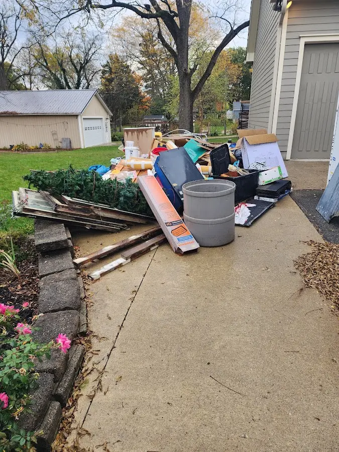 Dumpster being loaded with debris for Estate Cleanout Dumpster Rental in Oxford